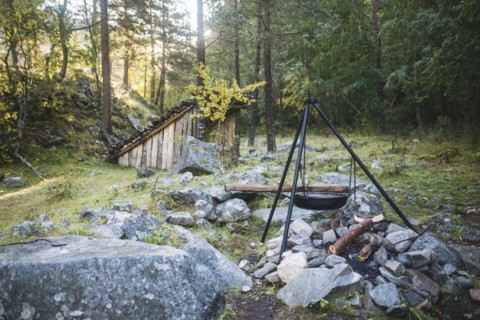 Cooking pot on tripod above campfire
