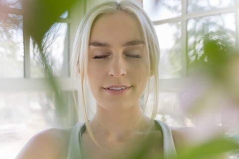 Portrait of young blonde woman with eyes closed