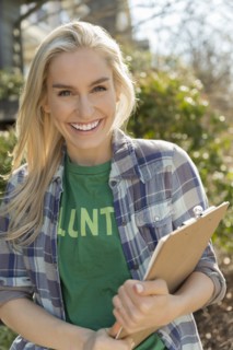 Smiling woman holding clipboard
