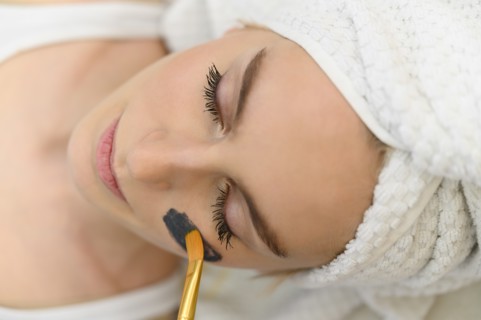 Face mask being applied on woman's face at spa