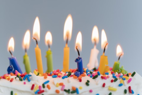Lit birthday candles on cake