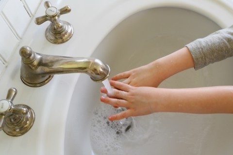 Close-up of boy (4-5) washing hands