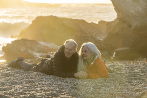 Senior couple enjoying sunset on beach