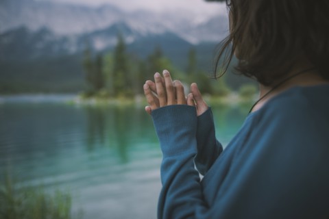 Germany, Bavaria, Eibsee, Young woman standing by Eibsee lake in Bavarian Alps
