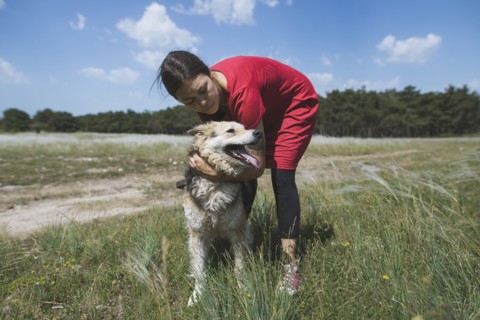 Young woman walking dog from animal shelter