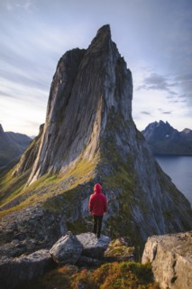 Norway, Senja, Man standing in front of Segla mountain at sunrise