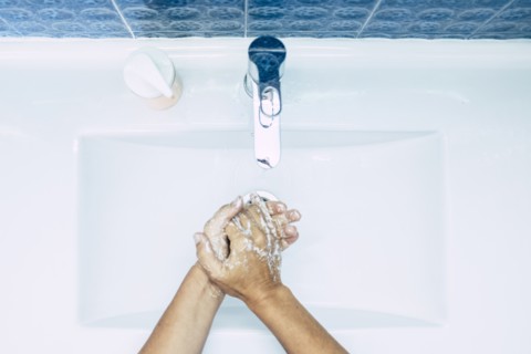 Close-up of teenage boy (16-17) washing hands