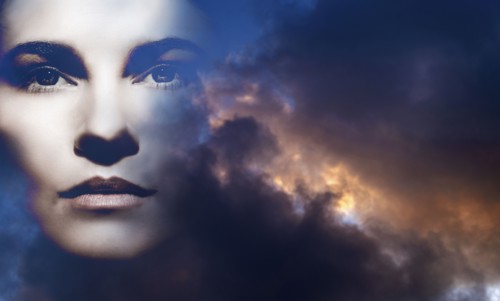 Double exposure of woman and overcast sky