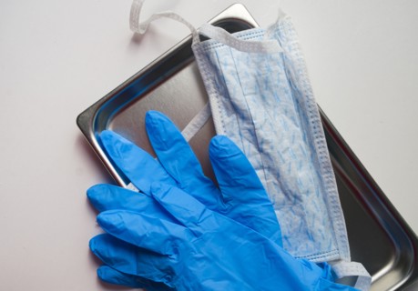 Latex gloves and hygiene mask on tray
