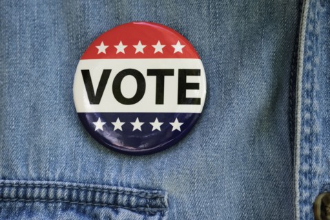 Vote button on denim jacket