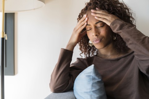 Woman with headache holding her head