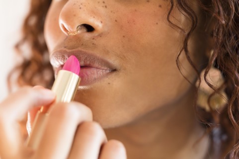 Woman applying lipstick