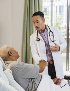 Senior man and doctor shaking hands