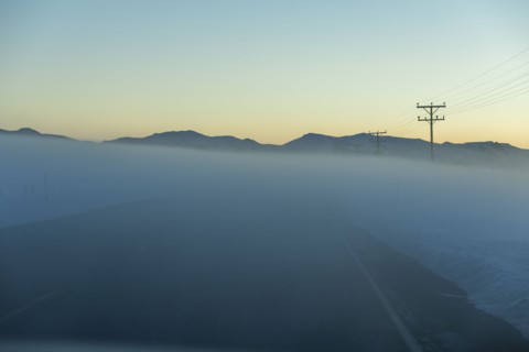 Road in fog at sunrise