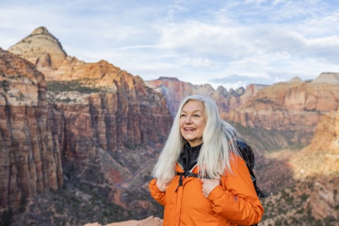 Smiling woman by canyon at Zion National Park in Utah, USA