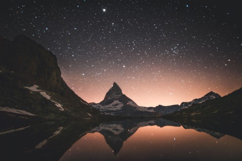 Matterhorn mountain and lake at night in Valais, Switzerland