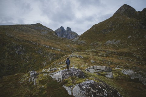 Man standing on mountain in Lofoten Islands, Norway