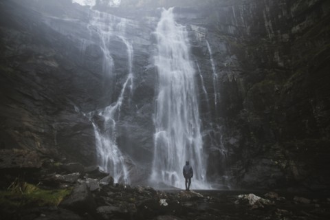 Man standing by Skjervefossen waterfall in Norway