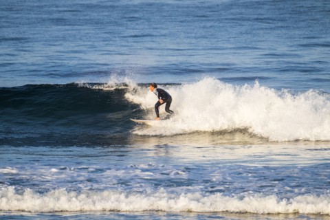 Teenage boy surfing waves
