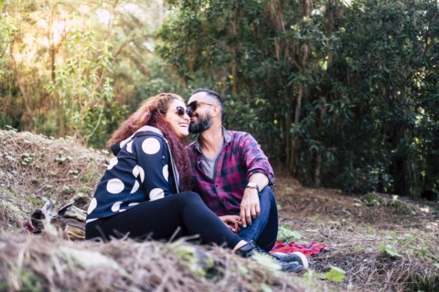 Smiling couple sitting on grass