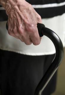 Close up of hand of senior woman holding cane