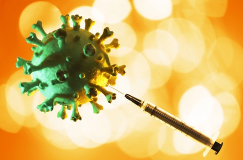 Model of Coronavirus with hypodermic needle