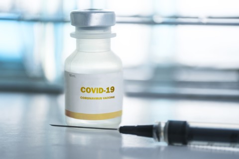 Vial of covid-19 vaccine and hypodermic needle