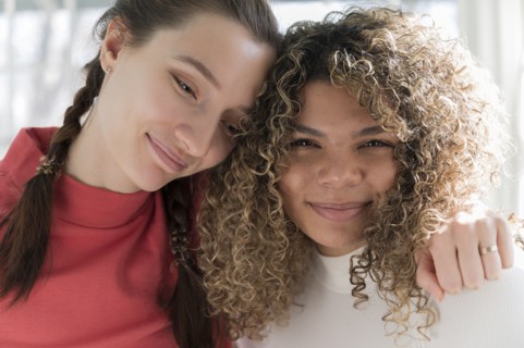 Portrait of embracing friends