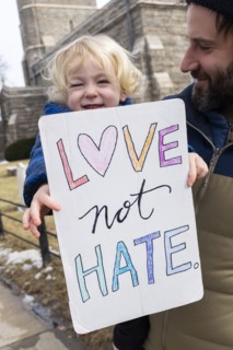 Father with little son holding peaceful protest sign