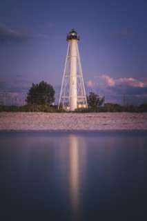 USA, Florida, Boca GrandeLighthouse reflecting in sea at night