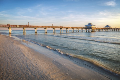 USA, Florida, Fort Myers Beach, Pier in sea at sunset