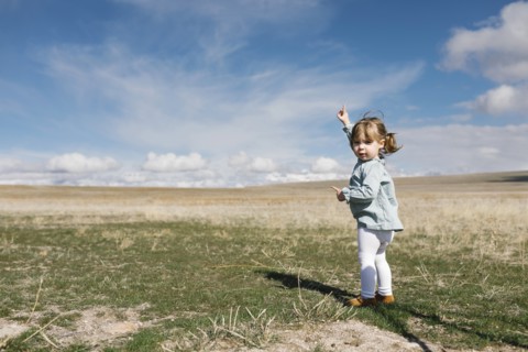 Girl (2-3) pointing towards sky