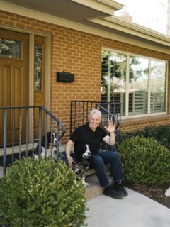 English springer spaniels and owner in front of house