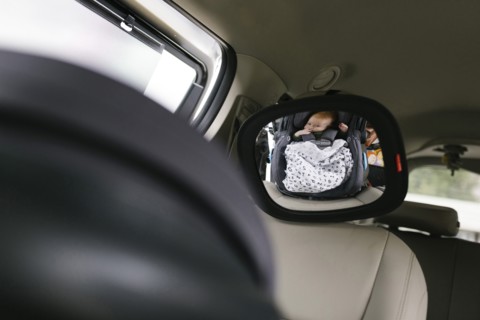 Reflection of baby boy (2-3 months) in car mirror
