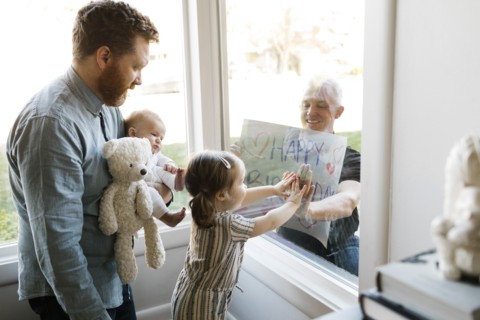 Grandfather visiting family with grandchildren