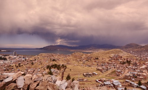 Peru, Sillustani, Storm clouds over village