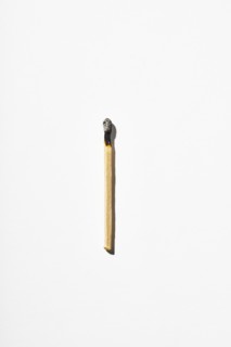 Burnt matchstick on white background