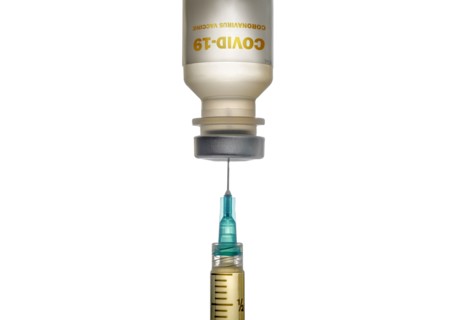 Studio shot of Covid-19 vaccine and syringe on white background