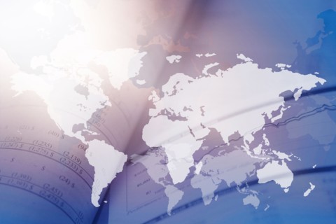 Digitally generated image of world map with financial data in background