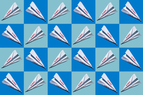Studio shot of paper planes with Covid-19 sign