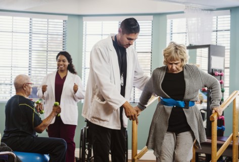 Senior people exercising with therapists during physical therapy