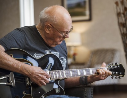 Senior man playing guitar