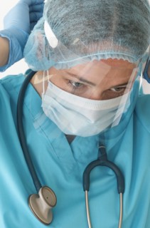 Nurse putting on face shield