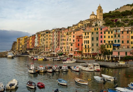 Italy, Cinque Terra, Boats in harbor with town in background