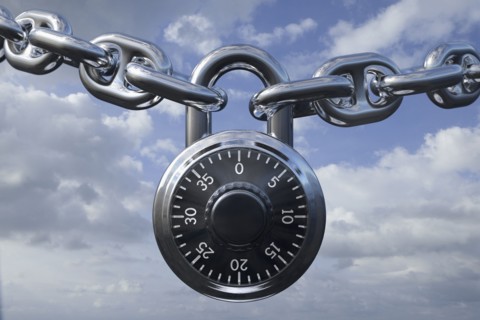 Padlock on chain against clouds