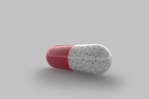 Studio shot of red and white capsule