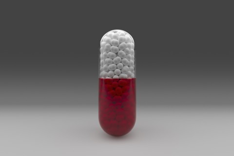 Studio shot of red and white capsule