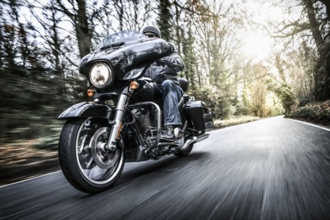 United Kingdom, London, Motorcyclist on road in forest