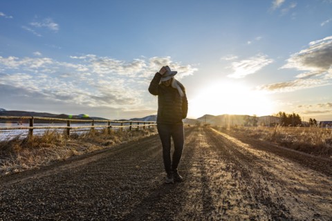 USA, Idaho, Sun Valley, Woman at sunrise on rural road