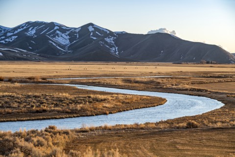 USA, Idaho, Picabo, Landscape with Silver Creek fields and mountain range